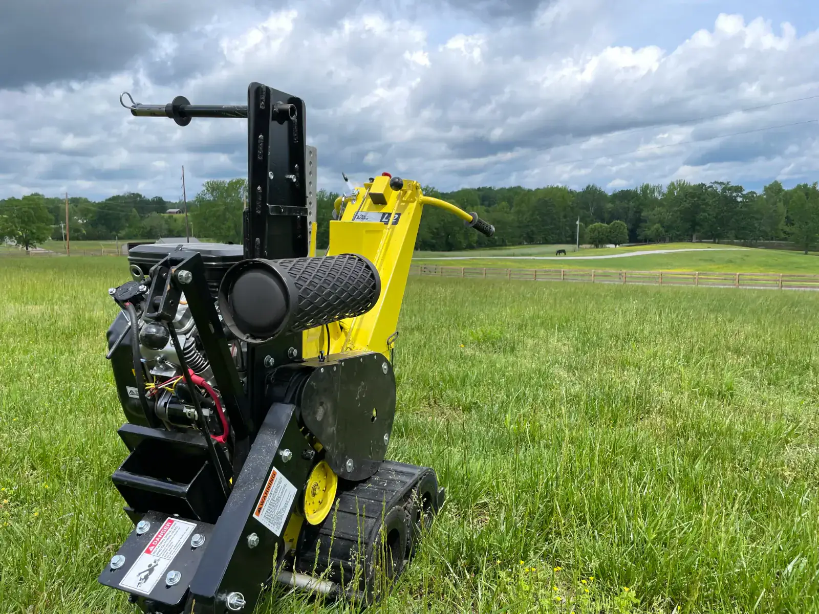 The L2 Line Layer trenchless wire burial machine in a Middle Tennessee field, used by Light TN to bury low-voltage cable without trenching